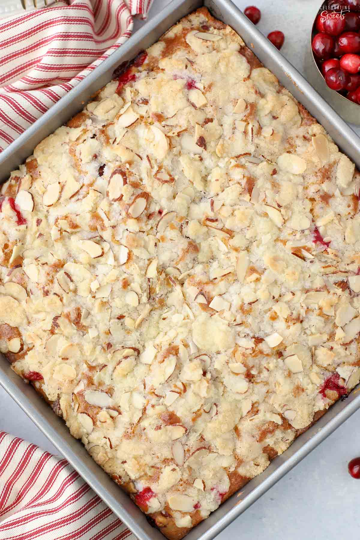 Overhead shot of a cranberry cake topped with almond streusel in a square baking pan.