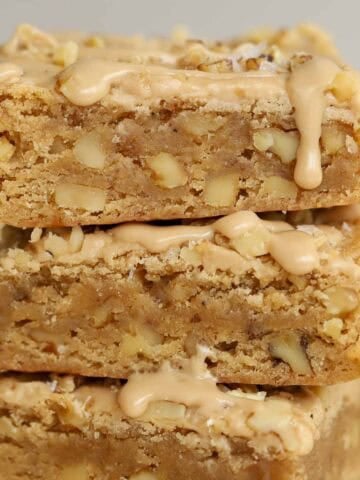 Stack of three maple walnut bars drizzled with maple icing.