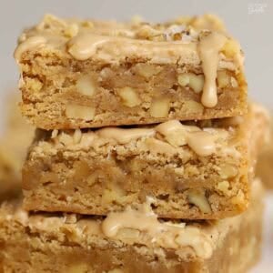 Stack of three maple walnut bars drizzled with maple icing.