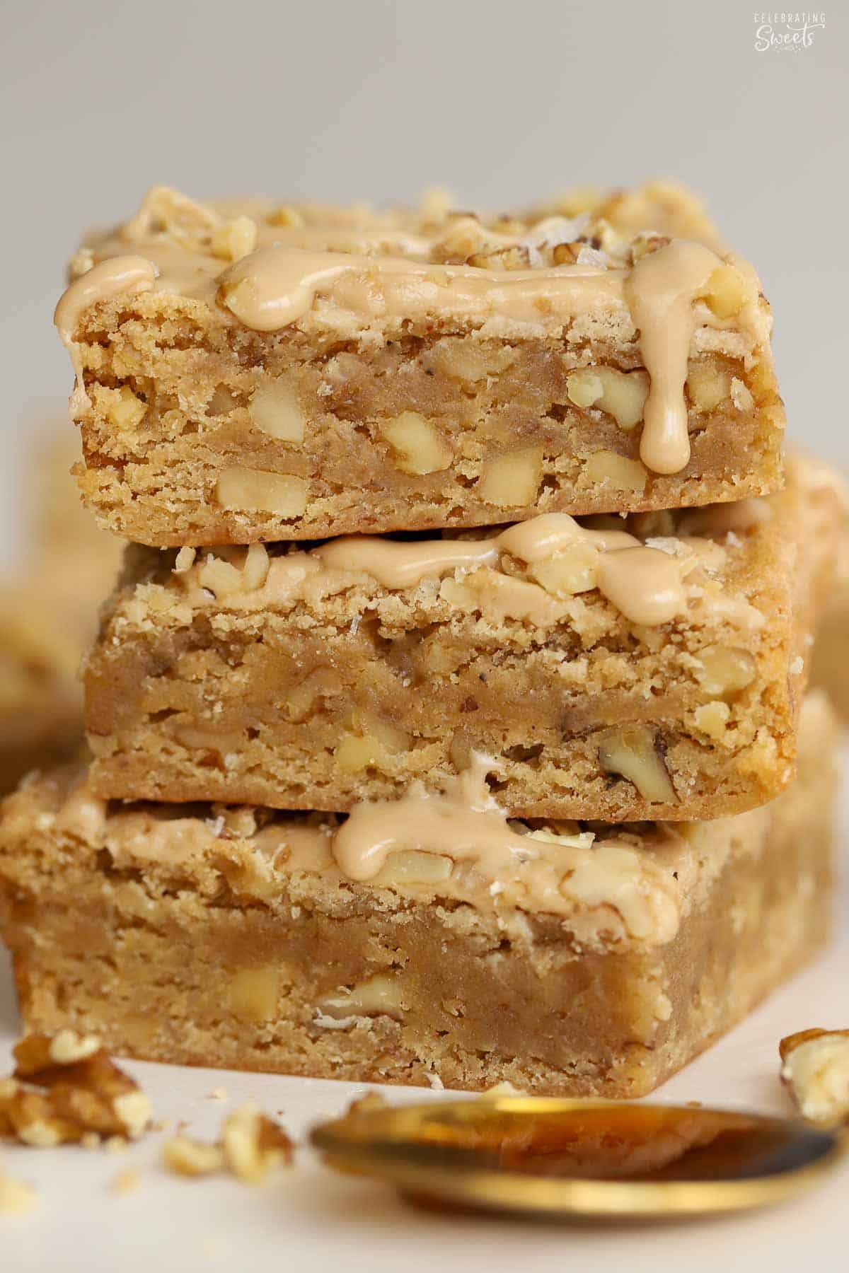 Stack of three maple walnut bars drizzled with maple icing.