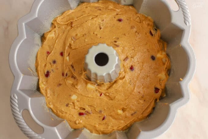 Pumpkin bundt cake batter in a metal bundt pan.