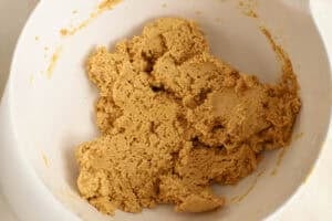 Peanut butter dough in a large white bowl.