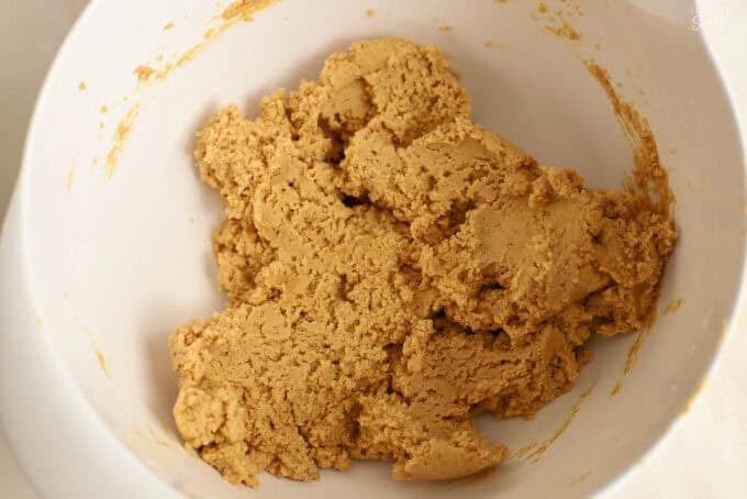 Peanut butter dough in a large white bowl.
