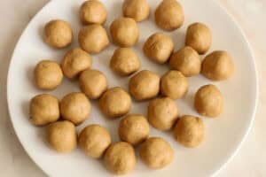 Peanut butter balls on a white plate.