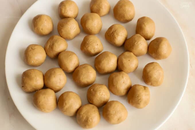 Peanut butter balls on a white plate.