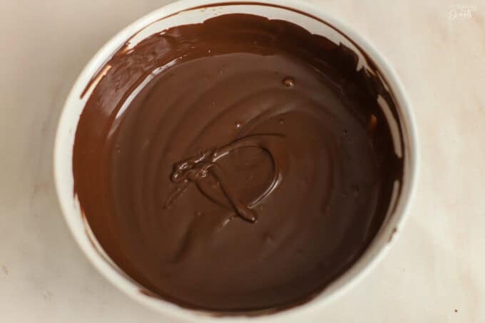 Melted chocolate in a white bowl.