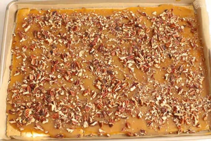 Unbaked pecan toffee on a baking sheet.