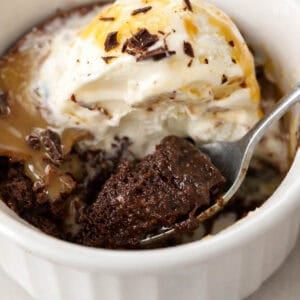 Brownie pudding topped with vanilla ice cream and caramel sauce.