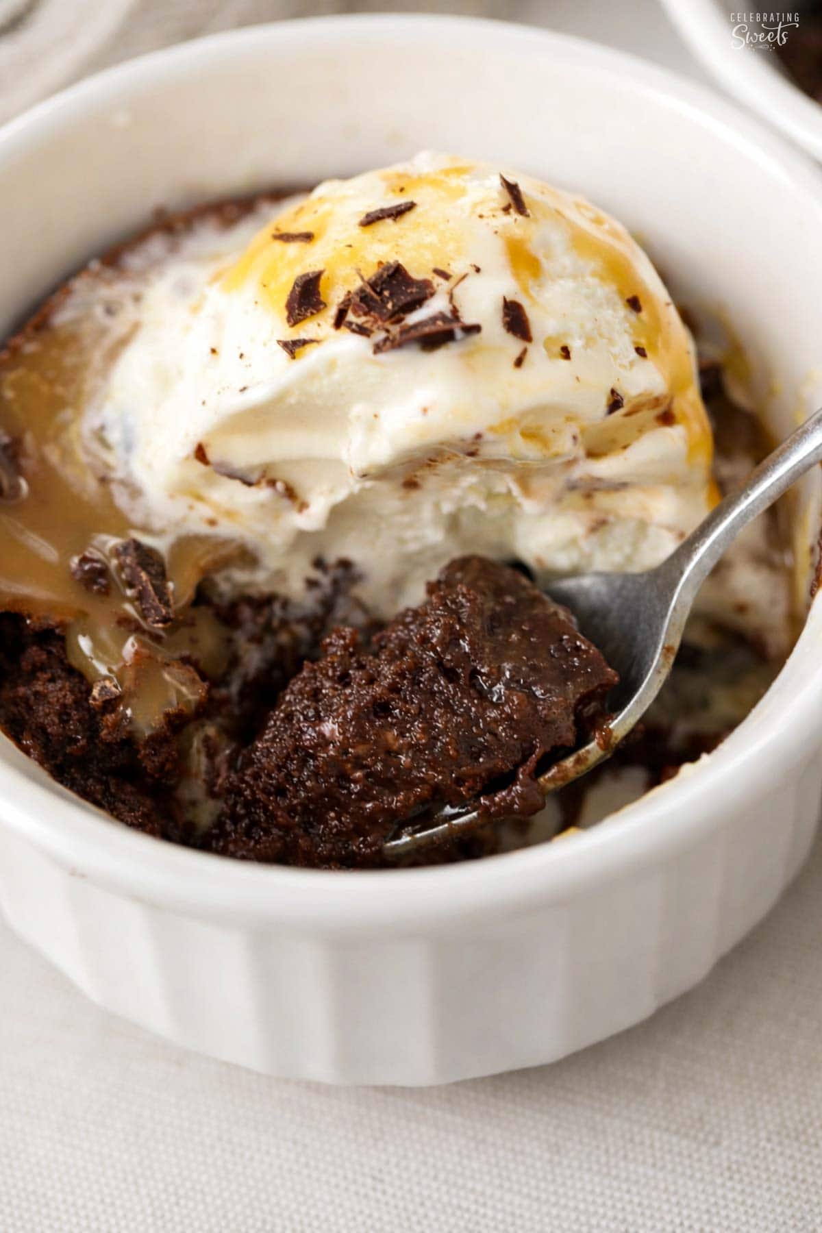 Brownie pudding topped with vanilla ice cream and caramel sauce.