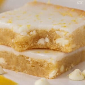 Stack of two lemon brownies topped with white icing.