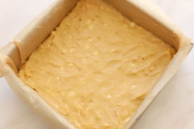 Lemon brownie batter in a square baking pan.