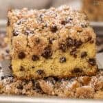 A slice of chocolate chip crumb cake on a metal spatula.