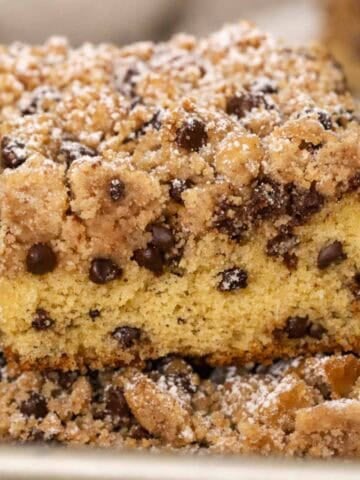 A slice of chocolate chip crumb cake on a metal spatula.