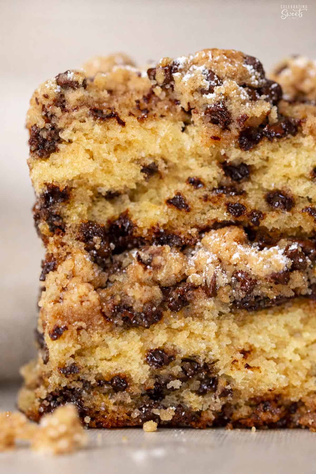 Two pieces of chocolate chip crumb cake stacked on top of each other.