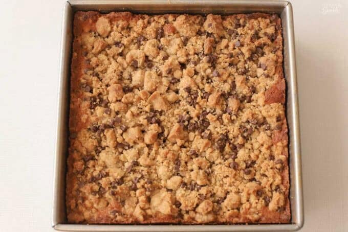 Chocolate chip crumb cake in a square metal pan.