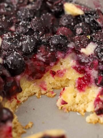 Lemon blueberry spoon cake in a metal baking pan.