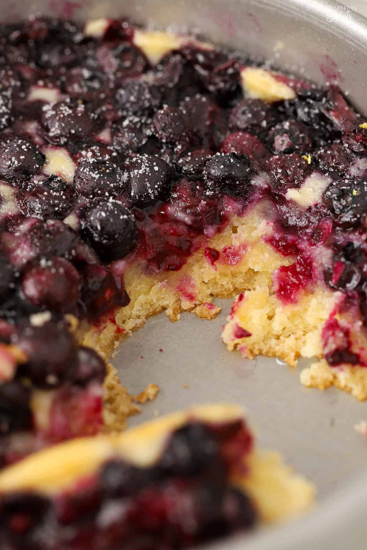Lemon blueberry spoon cake in a metal baking pan.