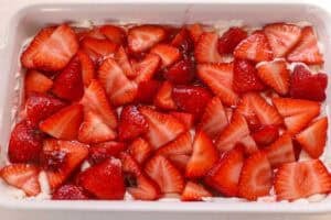 Strawberry tiramisu in a white rectangular baking dish.