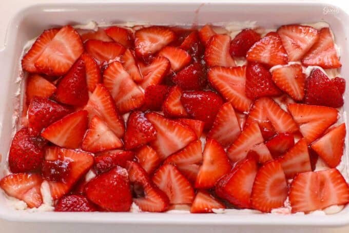 Strawberry tiramisu in a white rectangular baking dish.