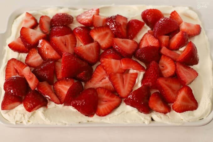 Strawberry tiramisu in a white rectangular baking dish.