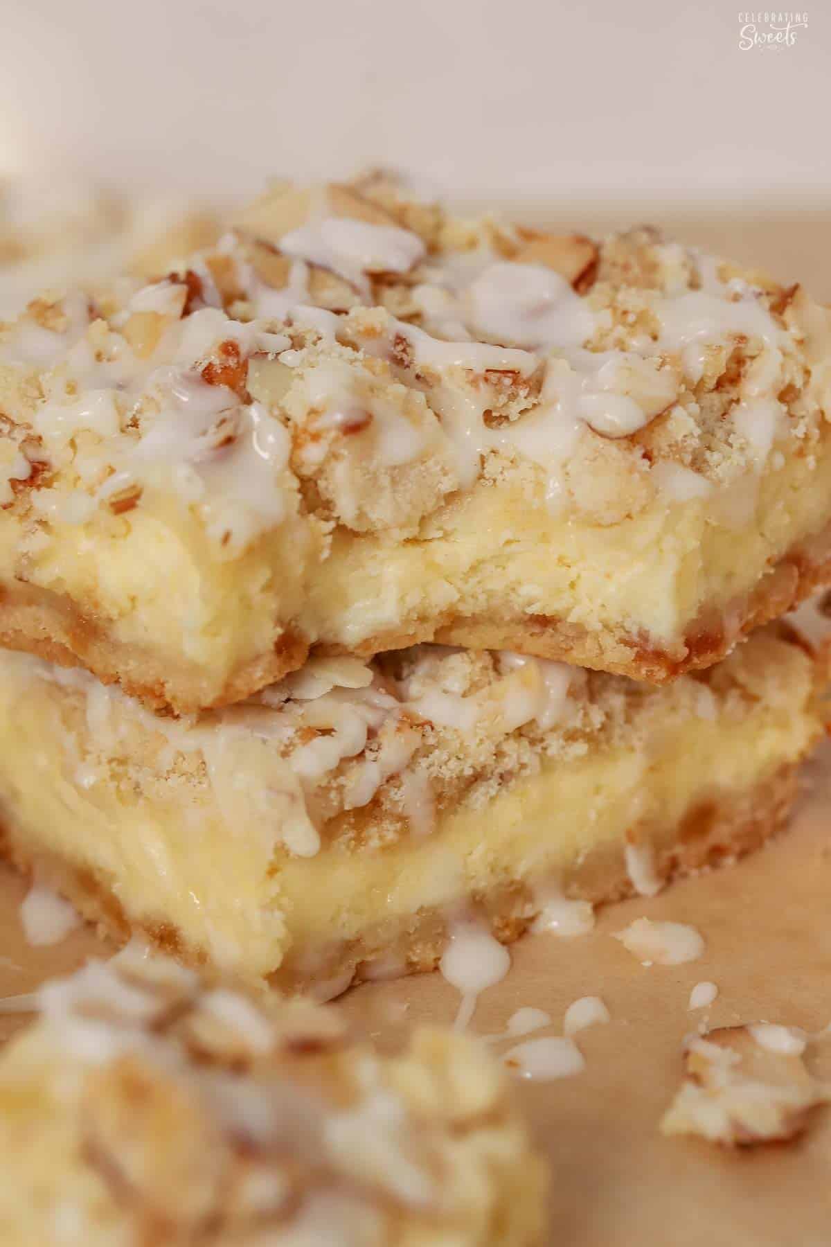 Two almond cheesecake bars stacked on top of each other.