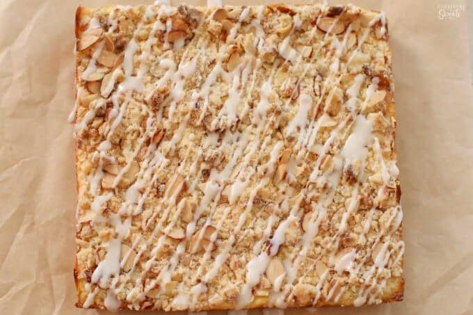 Almond crumble bars on a piece of parchment paper.