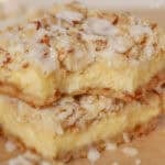 Two almond cheesecake bars stacked on top of each other.