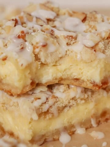 Two almond cheesecake bars stacked on top of each other.