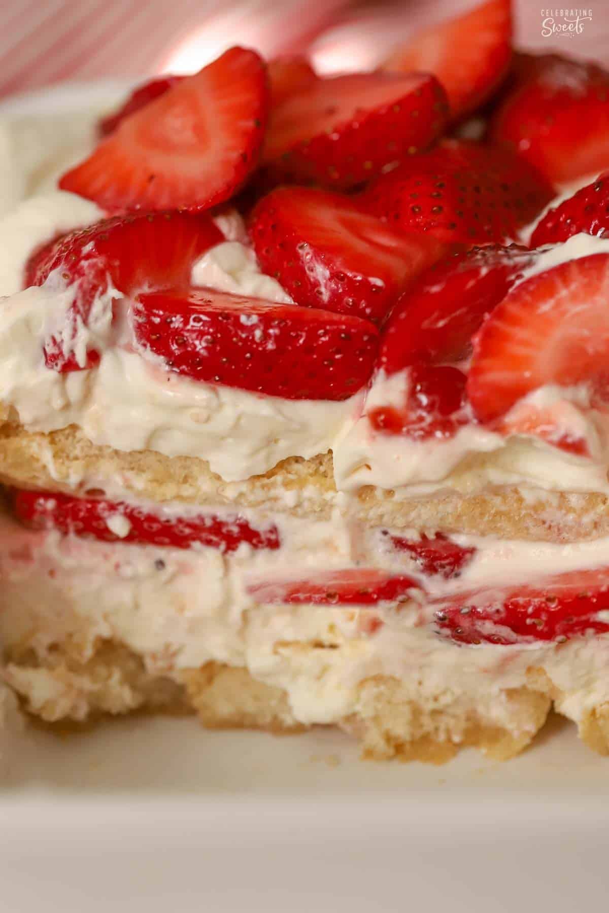 Layered strawberry tiramisu in a white baking dish.