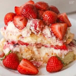A serving of strawberry tiramisu on a white plate.