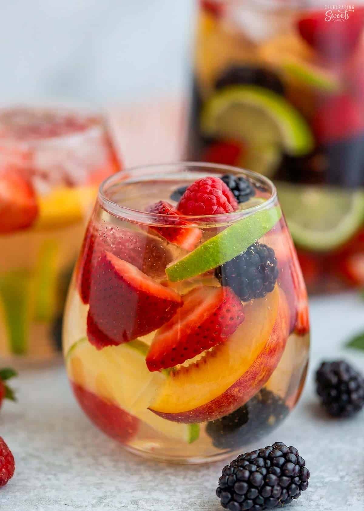 White sangria and fresh fruit in a stemless wine glass.