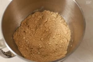 Dry ingredients (flour, sugar, oats) in a metal mixing bowl.
