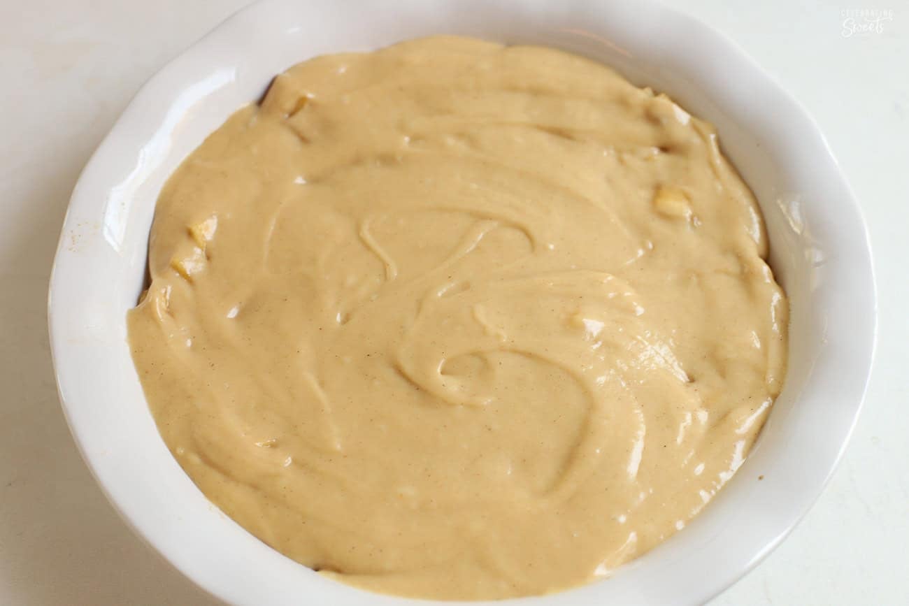 Cake batter in a round white baking dish.