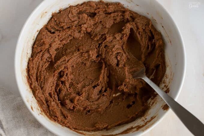 Brown sugar cinnamon butter in a white bowl with a fork in it.