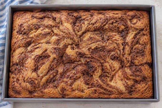 Maple cinnamon swirl cake in a metal cake pan.