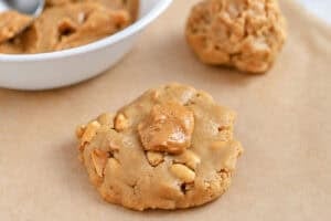 Flatten cookie dough with a spoonful of peanut butter in the center.